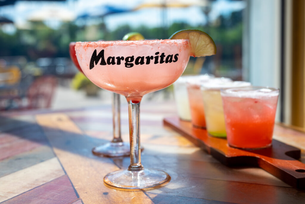 A pink watermelon coconut margarita on a table